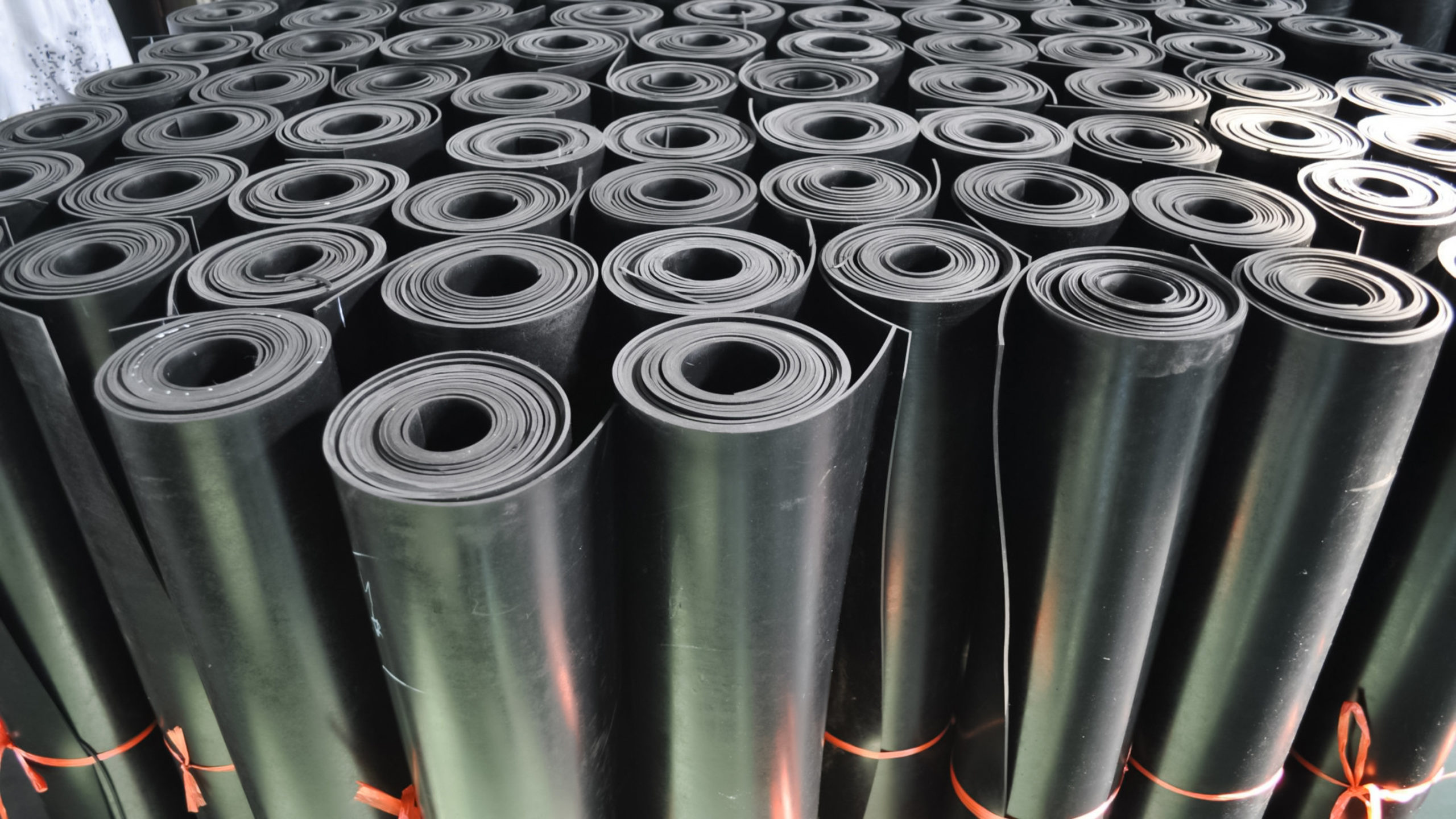 warehouse rolls of commercial rubber. black coating rolls.